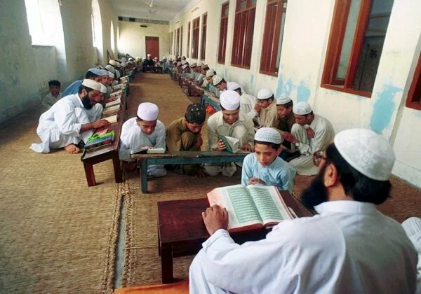 Muslim Students recite lines at a Madrassa in Pakistan Students recite lines at a Madrassa in Pakistan Muslim Students recite lines at a Madrassa in Pakistan