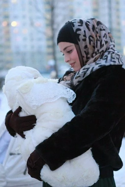 Hijab Women holding her baby Hijab Women holding her baby Hijab Women holding her baby